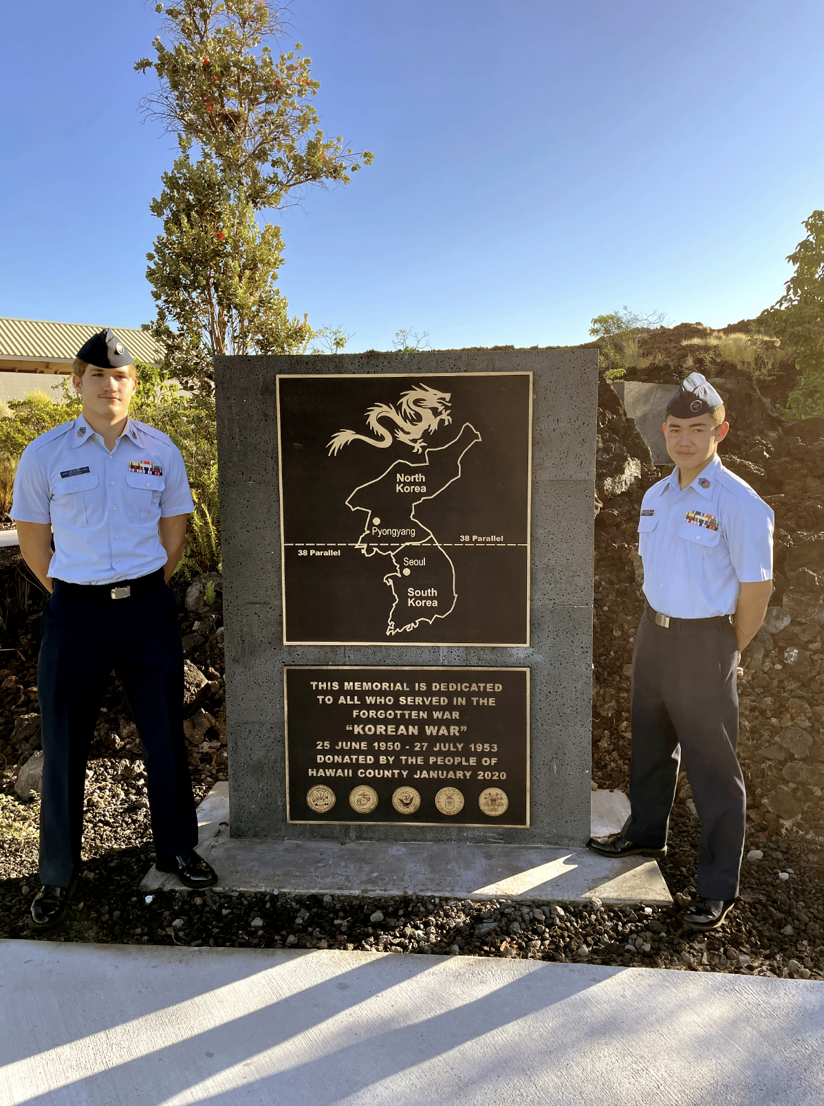 Cadet Master Sgt Asher McCarty and Cadet Master Sgt Michael Evans stand at ease beside the Memorial to those serving in the Korean War.